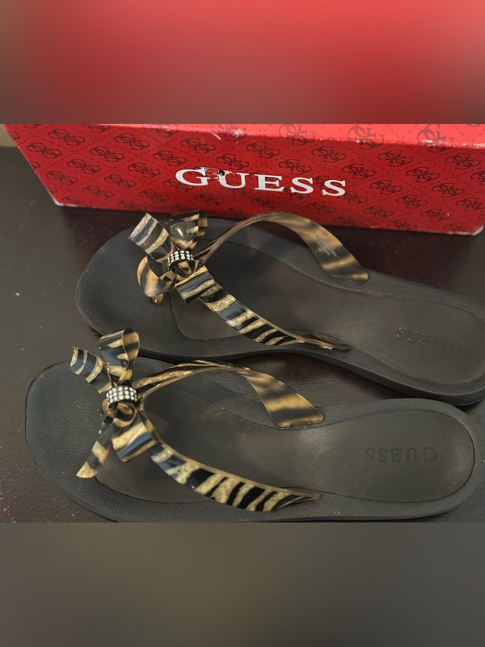 GUESS Black Sandal Flip Flops with Gold-Tone Zebra Bow Accent